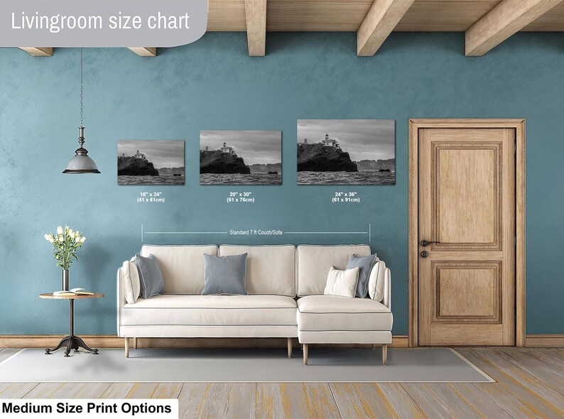 May include: A living room size chart displaying three black and white landscape prints of a lighthouse on a cliff. The prints are labeled with dimensions of 18 by 24 inches, 20 by 30 inches, and 24 by 36 inches, positioned above a beige sectional sofa.