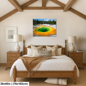 May include: A rectangular wall art print featuring a vibrant geothermal pool with a deep green center surrounded by bright orange and yellow mineral deposits, set against a forest backdrop, measuring 30 by 40 inches in total dimensions.