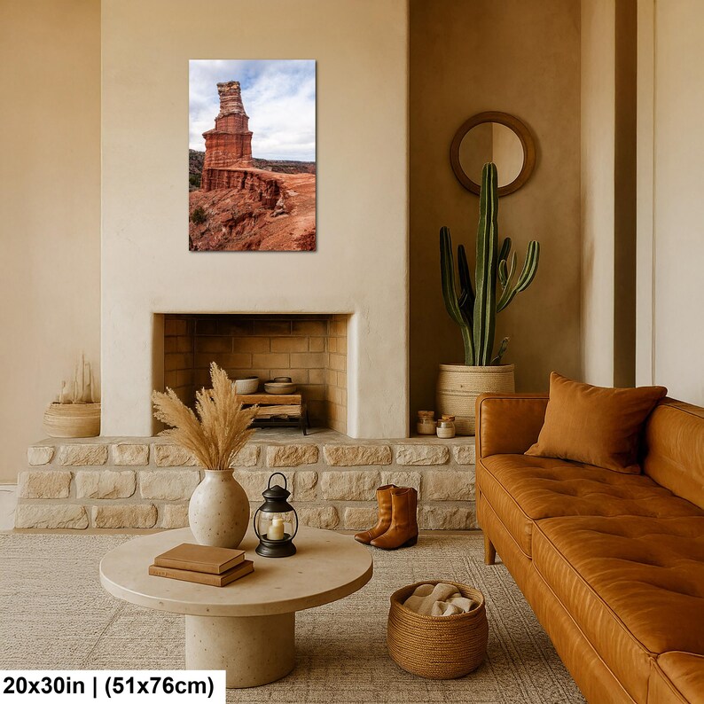 May include: A rectangular wall art print featuring a tall, weathered red sandstone rock formation under a cloudy sky. The print measures 20 inches by 30 inches and displays a desert landscape with layered geological textures and earthy tones.