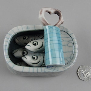 Ceramic sardines in a Tin