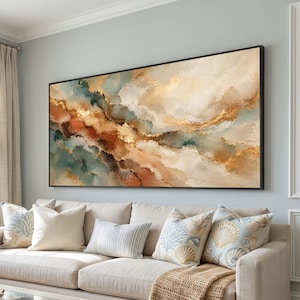 May include: A large rectangular wall art piece featuring an abstract landscape design with flowing layers of cream, deep teal, burnt orange, and metallic gold paint. The artwork is framed in a thin black border and displayed horizontally.