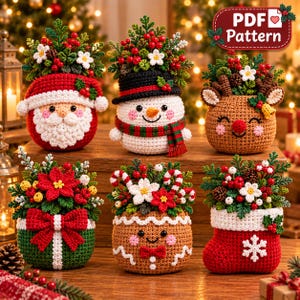 May include: Six crocheted Christmas-themed ornaments featuring a Santa Claus, a snowman, a reindeer, a gift box, a gingerbread person, and a stocking. Each figure is topped with a decorative arrangement of green foliage, red berries, and white flowers.