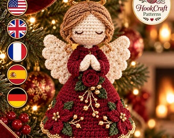 May include: A crocheted angel ornament with light brown hair, a gold halo, and white wings. The angel wears a dark red dress adorned with a central red rose, green leaves, and gold bead accents. The text HookCraft Patterns is visible in the corner.