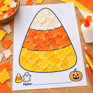 May include: A white paper sheet featuring a large candy corn shape filled with torn pieces of white, orange, and yellow paper. Below the shape are small illustrations of a candy corn, a ghost, a pumpkin, and the printed text Name: with a line.