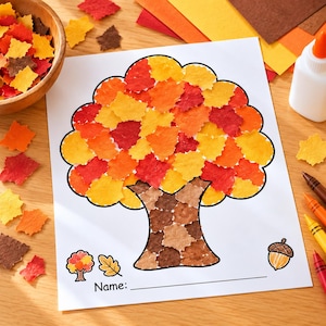 May include: A white paper sheet featuring a tree outline filled with small, square-cut paper pieces in shades of red, orange, yellow, and brown. The tree trunk is covered in brown paper squares, and the bottom includes an acorn icon and a name line.