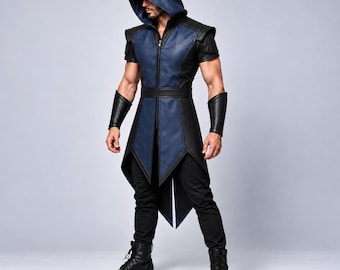 May include: A sleeveless hooded tunic featuring a central blue panel flanked by black side panels, a full-length front zipper, and structured shoulder details. The garment is paired with matching black forearm gauntlets and black trousers.