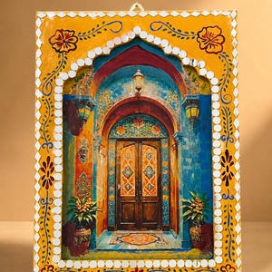 May include: A rectangular wall hanging featuring a painted scene of an arched doorway with double wooden doors, flanked by potted plants. The frame is painted yellow with floral motifs and bordered by small, reflective, diamond-shaped mirrors.