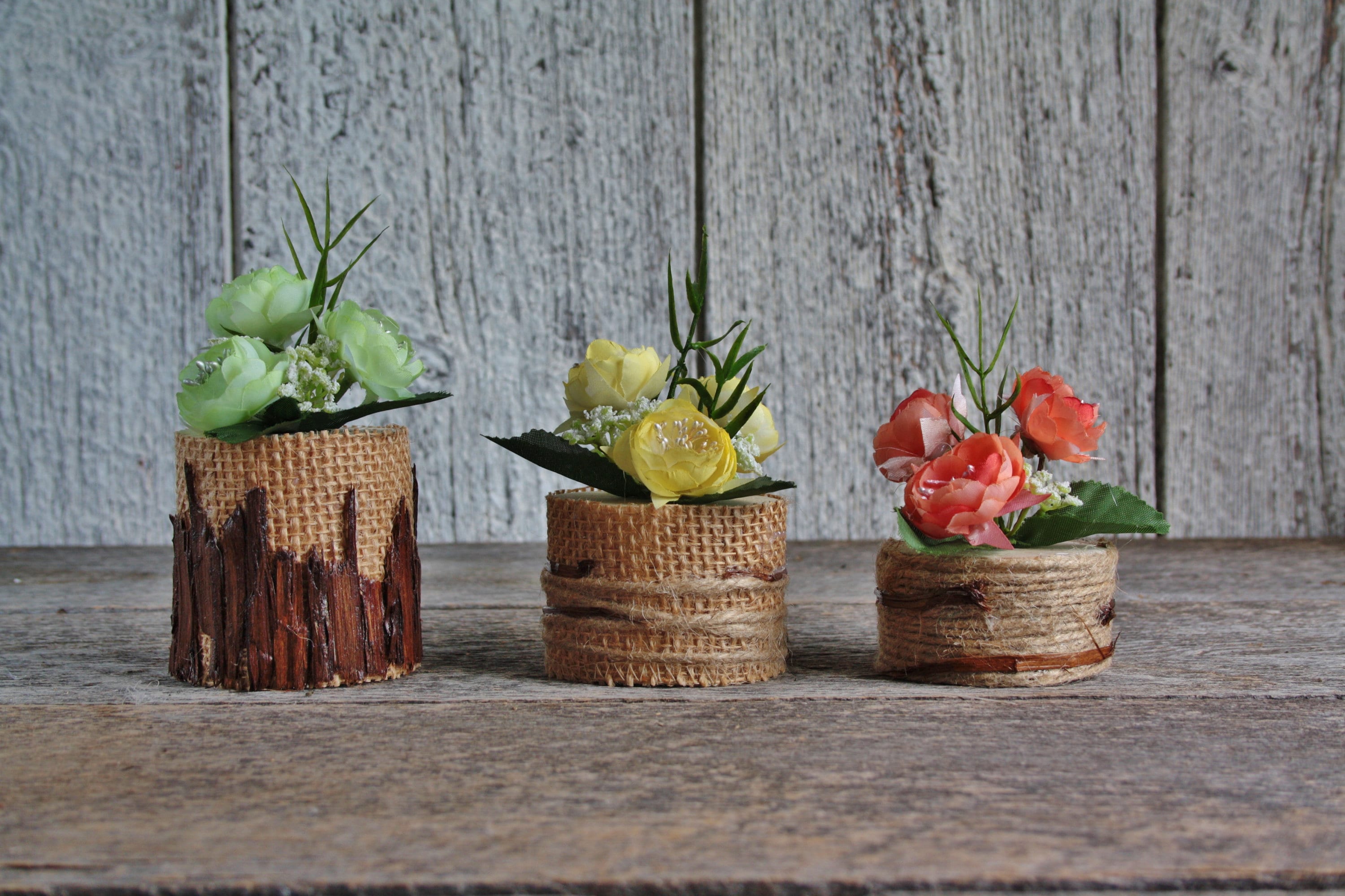 Flower arrangement on small log of wood decorated with cedar Etsy