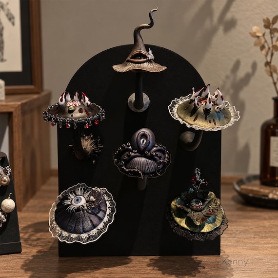 A handmade mushroom figurine with an eyeball centre that sits right at the crossroads of dark fantasy art and maximalist shelf decor — genuinely one-of-a-kind craft.