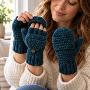 Puede incluir: Un par de mitones convertibles de ganchillo en color verde azulado oscuro con puño acanalado y una tapa abatible que se asegura con un pequeño botón marrón. El diseño permite usarlos como guantes sin dedos al plegar la tapa hacia atrás.