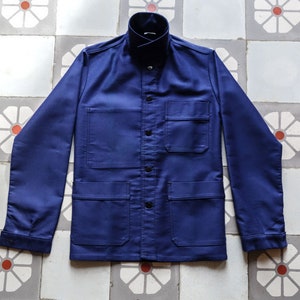 May include: A navy blue work jacket with multiple pockets and a button-up front.