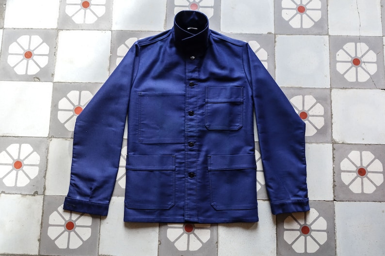 May include: A navy blue work jacket with multiple pockets and a button-up front.