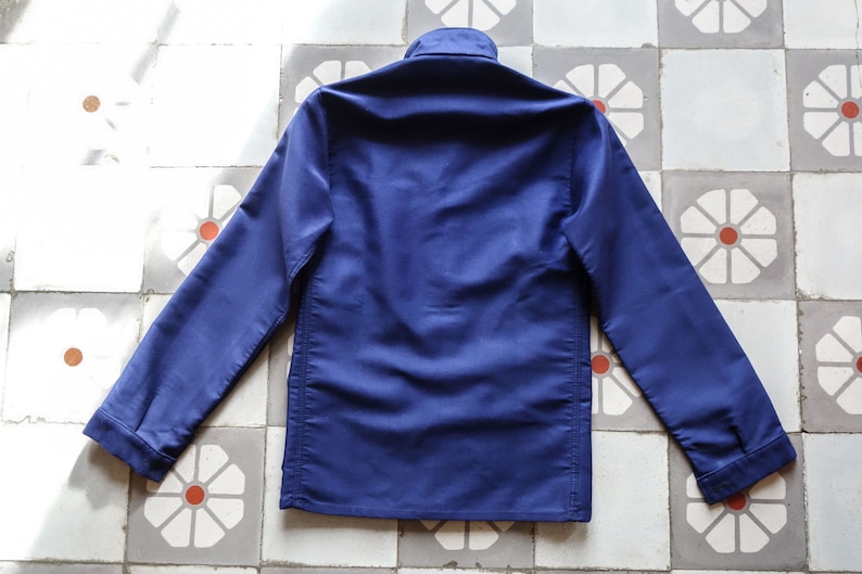 May include: A dark blue long-sleeved work jacket with a button-up collar and a straight hem.