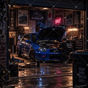 May include: A blue Subaru WRX STI with its hood open inside a garage. The garage features a neon STI sign, various automotive posters, and tools. The car is parked on a wet floor with a floor jack nearby. The scene includes text like Subaru, STI, and Eat Sleep Build Drive Repeat.