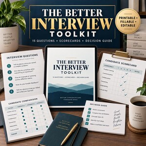 May include: The Better Interview Toolkit includes a tablet displaying a mountain graphic, a printed interview questions sheet, a candidate scorecard, a candidate comparison chart, a decision guide, and a dark blue notebook with a gold pen.