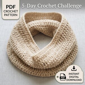 May include: A beige crochet infinity scarf with a textured stitch pattern. The image includes text that reads 5-Day Crochet Challenge, PDF CROCHET PATTERN, and INSTANT DIGITAL DOWNLOAD, indicating this is a digital file for a craft project.