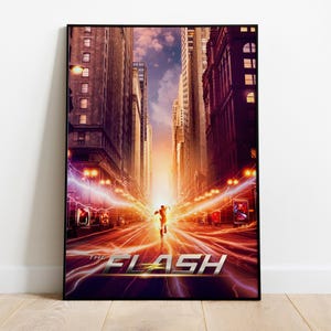 May include: A framed film poster featuring a central figure running down a city street at sunset, surrounded by bright yellow and purple lightning bolts. The text THE FLASH is displayed in large, bold, metallic silver letters at the bottom.