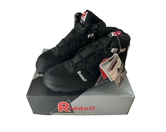 May include: Pair of black Riddell high-top athletic shoes with white accents and a strap closure system. The shoes are on top of a Riddell box with the logo and text "QUALITY SINCE 1929". Includes a hang tag.
