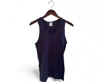 May include: A navy blue vest top suspended from a wooden clothes hanger. The sleeveless top features a scoop neck and a small label near the neckline. The background is plain white.