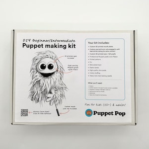 May include: A white rectangular box for a DIY Beginner/Intermediate Puppet making kit. The label features a black and white illustration of a furry creature, a list of included materials like 3D printed mouth plates and nylon fleece, and the Puppet Pop logo.