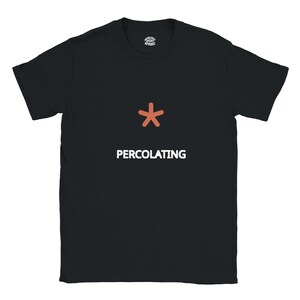 May include: A black short-sleeved t-shirt featuring a centred orange asterisk symbol above the white text PERCOLATING. The inner neck label displays the text ABSOLUTELY RIGHT APPAREL. The garment has a crew neckline and a standard straight hem.