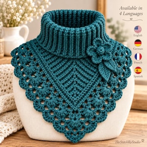 May include: A teal crochet dickey featuring a ribbed turtleneck collar and a decorative flower appliqué with leaves. The garment displays intricate stitch patterns and a scalloped edge. Text on the image reads: Available in 4 Languages, English, German, French, Spanish, and TheStitchRoStudio.