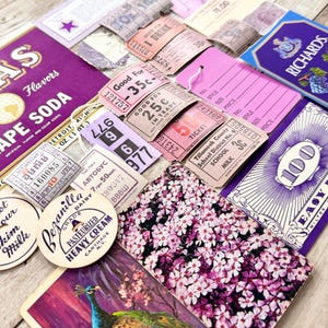 May include: A collection of vintage ephemera, including tickets, labels, and a small purple box with the text "Richards Concord Wine". The ephemera features a variety of colors, including purple, pink, and white. The items are arranged on a wooden surface.