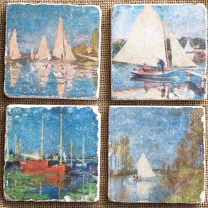 May include: Set of four square coasters featuring vintage-style paintings of sailboats on water. The coasters are made of natural stone with a rustic, textured surface.