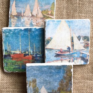 May include: Set of four square coasters featuring vintage paintings of sailboats on a body of water. The coasters are made of a light gray stone with a rough texture.