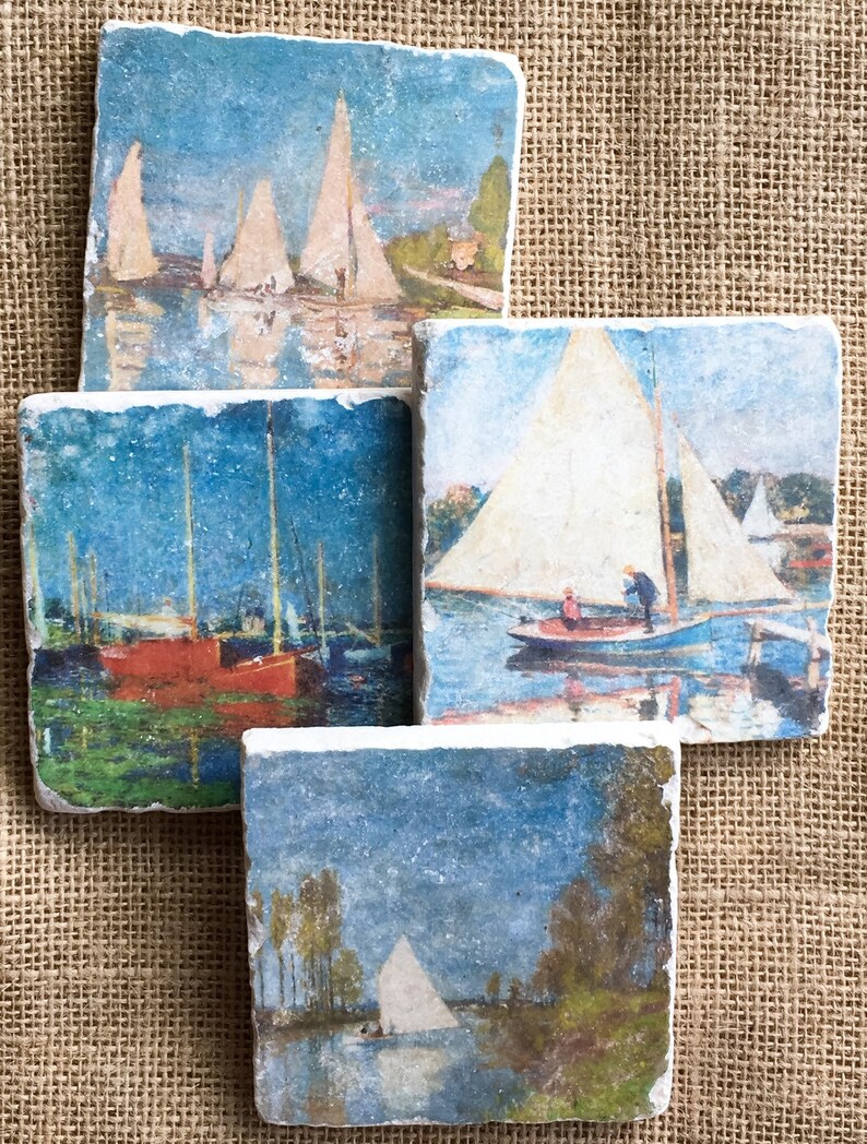 May include: Set of four square coasters featuring vintage paintings of sailboats on a body of water. The coasters are made of a light gray stone with a rough texture.
