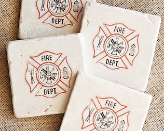 May include: Four square white coasters with a red and black fire department logo. The logo features a fireman's helmet, an axe, a ladder, and a fire hydrant.