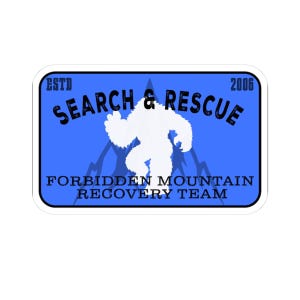 May include: A rectangular sticker with a blue background featuring a white silhouette of a yeti in the center. The text reads ESTD 2006, SEARCH & RESCUE, and FORBIDDEN MOUNTAIN RECOVERY TEAM in black lettering, with a dark blue mountain graphic behind the yeti.