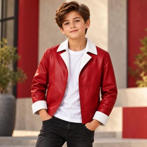 May include: A red jacket with a white collar and white cuffs worn over a plain white t-shirt and dark jeans. The jacket features a smooth texture, long sleeves, and a straight hemline, providing a clean and structured appearance for the garment.