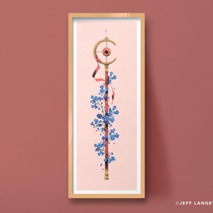 May include: A vertical framed art print featuring a golden staff topped with a crescent moon and a central red eye. The staff is wrapped in a red ribbon and adorned with clusters of blue flowers against a pale pink background. Text reads JEFF LANGEVIN.
