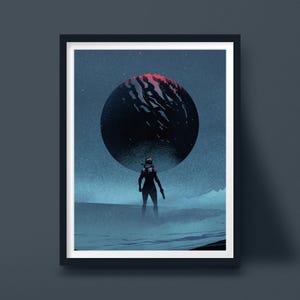 May include: A framed art print featuring a dark, silhouetted figure standing on a desolate, blue-toned landscape. Above the figure, a large, circular celestial body dominates the sky, displaying deep blue textures with a vibrant red glow.