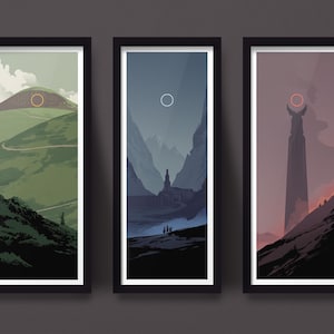 May include: Set of three framed landscape art prints. Each print features a minimalist design with a mountain or tower silhouette, a circular sun or moon, and a color palette of greens, blues, and reds. The frames are black.