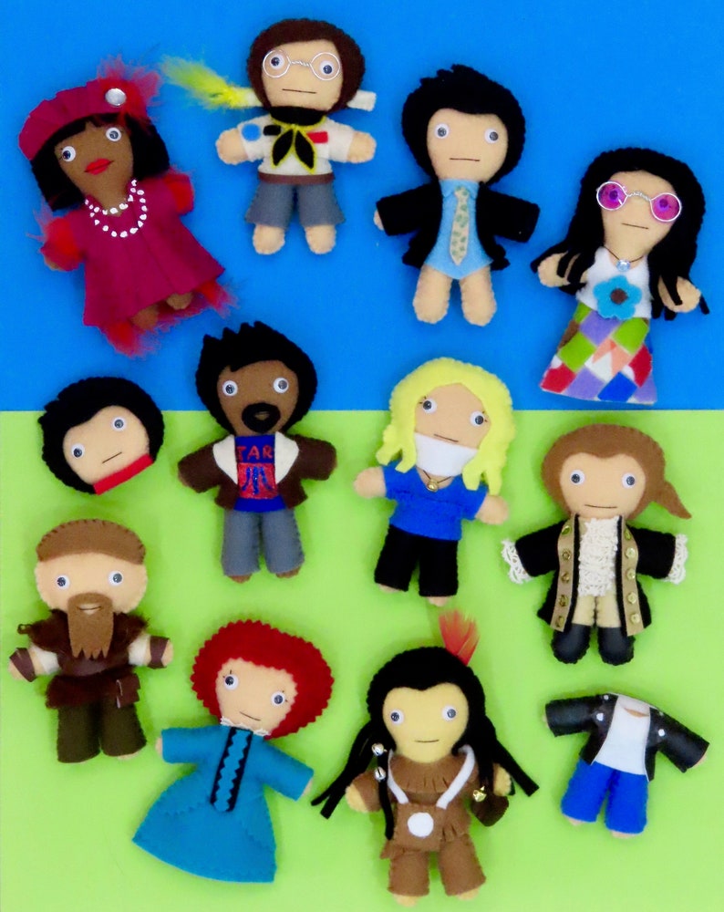 May include: A collection of handmade felt dolls, each depicting a different character. The dolls feature various outfits and accessories, including hats, glasses, and jackets. The dolls are arranged on a blue and green background.