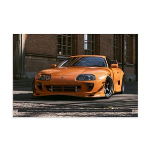 May include: An orange Toyota Supra MK4 sports car with a front bumper, headlights, and dark wheels. Text at the bottom reads: Toyota Supra MK4 1993 / Engine Inline6 twin turbo 3.0L / 0-100kph 4.9s / Maximum Speed 283kph / Maximum Power 330cv / Designer: Isao Tsuzuki.