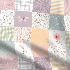 May include: A patchwork quilt featuring a range of floral and butterfly patterns in shades of pink, green, and yellow. The quilt is composed of squares with different designs, including gingham, polka dots, and floral prints.