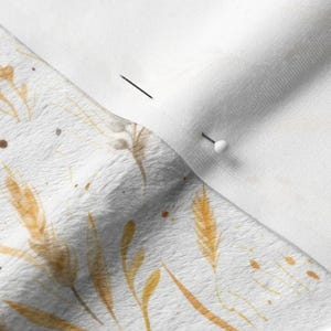 Close-up of sewing needle in minky fabric printed with French sourdough bread, vintage farmhouse loaf, earthy grain, and countryside wheat details