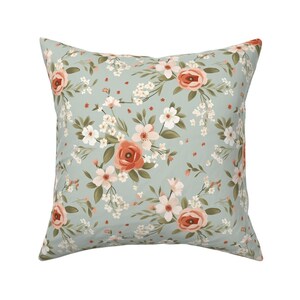 Pastel green floral fabric with peach flowers