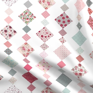 May include: A white background with a repeating pattern of pink, red, and gray diamond-shaped patchwork designs. Each diamond features a different floral or geometric pattern.