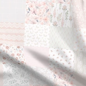 May include: A patchwork fabric with a variety of floral and lace patterns in shades of pink and white.