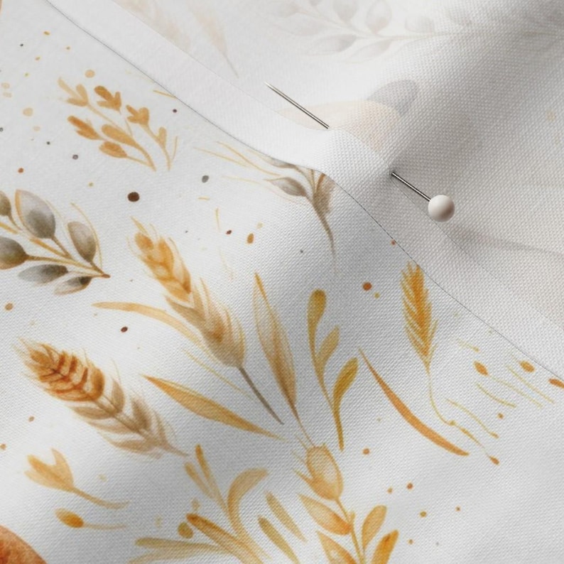 Detailed close-up of needle stitching into rustic French bread fabric by the yard in cotton, showing vintage beige loaf and countryside wheat quilting design