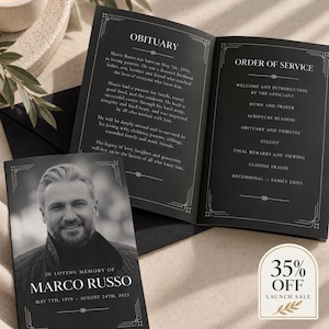 May include: A black funeral programme booklet featuring a portrait of Marco Russo on the cover with the text In Loving Memory of Marco Russo May 7th 1970 August 24th 2025. The interior pages display an obituary and an order of service in white text.