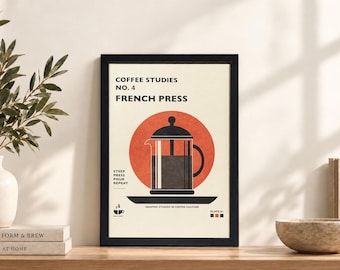 May include: A framed wall art print titled COFFEE STUDIES NO. 4 FRENCH PRESS. The cream-colored poster features a black French press illustration centered over a large orange circle, with the text STEEP PRESS POUR REPEAT and GRAPHIC STUDIES IN COFFEE CULTURE.