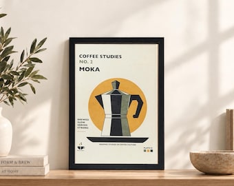 May include: A framed wall art print titled COFFEE STUDIES NO. 2 MOKA featuring a stylized illustration of a moka pot centered on a yellow circle. The text reads BREWED SLOW SERVED STRONG and GRAPHIC STUDIES IN COFFEE CULTURE with a small cup icon.