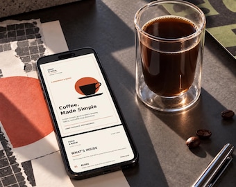 May include: A smartphone displaying a digital guide titled Form & Brew Coffee, Made Simple, next to a clear double-walled glass filled with black coffee and a silver metal pen. The screen shows text about coffee beans and brewing.