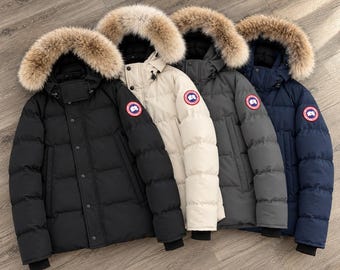 May include: Four insulated puffer jackets in black, cream, dark grey, and navy blue. Each jacket features a hood with a thick, fluffy brown fur trim, a front zip closure with snap buttons, and a circular red, white, and blue logo patch on the sleeve.