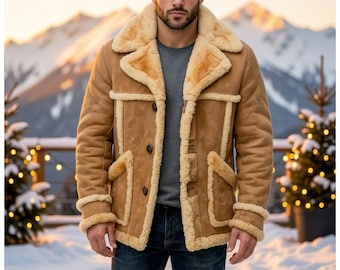May include: A tan suede jacket featuring a thick cream-colored shearling lining, a wide notched collar, and three front buttons. The jacket includes two front pockets with shearling trim and matching shearling cuffs on the long sleeves.